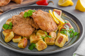 Schnitzel original with lemon and gnocchi fried