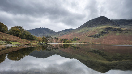 Stuning Autumn Fall landscape image of Lake Buttermere in Lake District England
