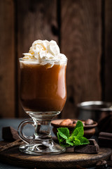 Iced cocoa drink with whipped cream, cold chocolate beverage, coffee frappe on dark background