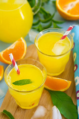Sweet orange drink with ice and mint leaves