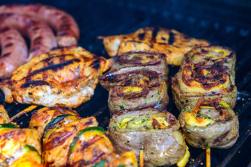 different meat and sausage on barbecue