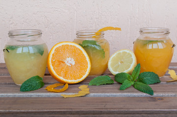 Obraz na płótnie Canvas Orange fresh and lemonade in jars