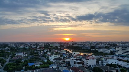 Another day sunrise and the city skyline with the dark cloud.
