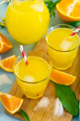 Sweet orange drink with ice and mint leaves