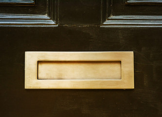 Old letterbox in the door, traditional way of delivering letters to the house, old mailbox
