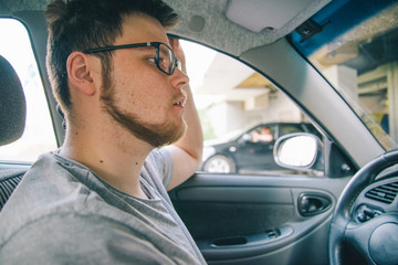 young man without experience driving car