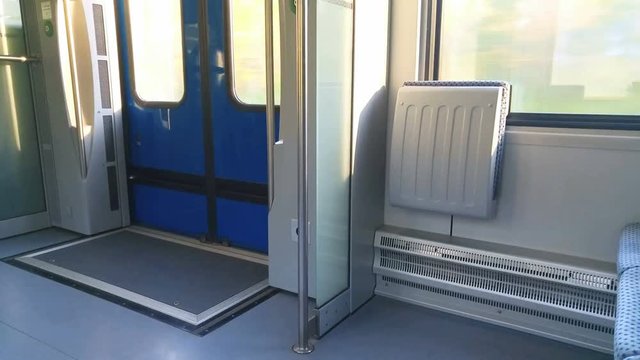 in the train next to the window, there are two chairs and door