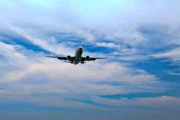 passenger plane flying in the blue sky