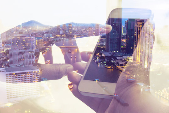 Double exposure image of people with smart phone and cityscape background,Business technology concept.