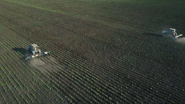 Two tractors performs seeding on the field