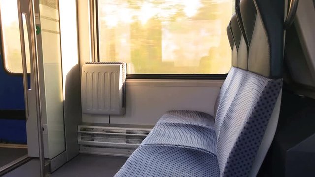 in the train next to the window, there are two chairs and door
