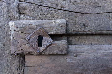vintage aged wooden door with keyhole in Matera, south Italy