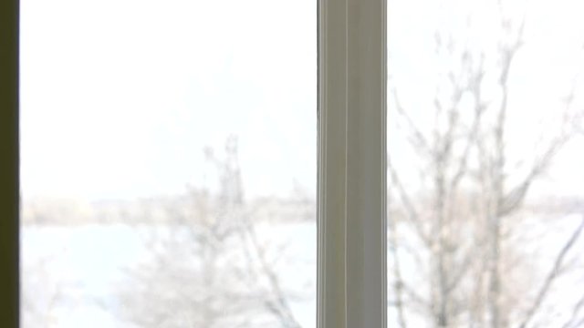 Housemaid washing window. Young woman working. House cleaning services.