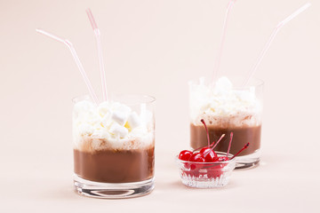 Two glasses of cocoa with whipped cream and marshmallows