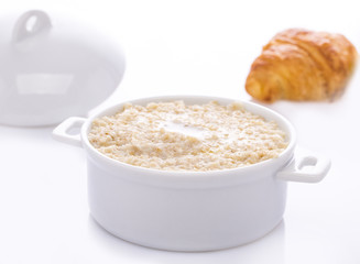 Oat porridge in a white saucepan. Oatmeal. Cap..