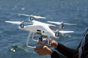 drone in hands with sea