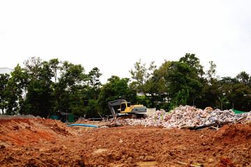 Fototapeta premium Excavator or backhoe at the construction site, reservoir construction