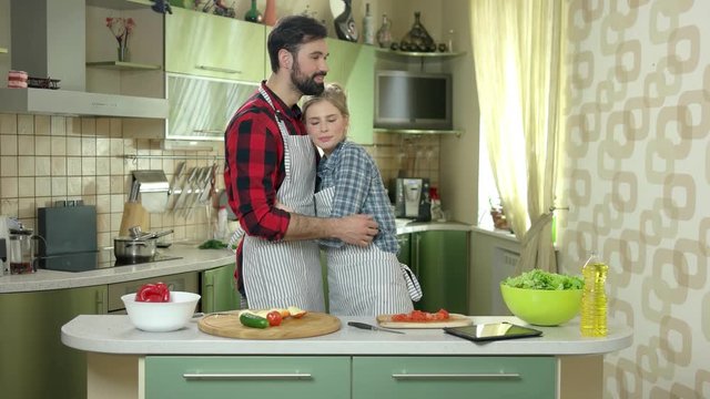 Man and woman hugging, kitchen. Happy caucasian people. Start cooking as a family.