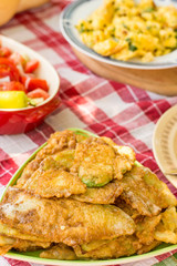 Served lunch with tomato salad and fried zucchini