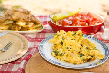 Served lunch with tomato salad and fried zucchini