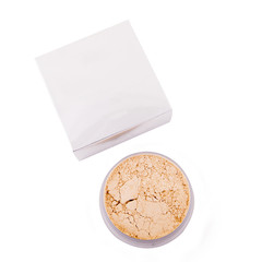 Cosmetic powder next to a box isolated over white background. Cosmetic products