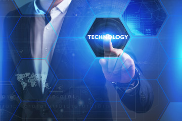 Business, Technology, Internet and network concept. Young businessman working on a virtual screen of the future and sees the inscription: Technology