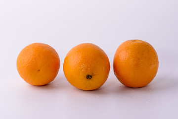 three oranges on white background