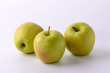 three green apples on white background