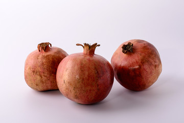 three pomegranates on a white background