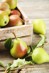 Ripe pears on grey wooden table
