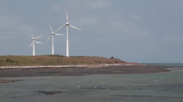 Wind power stations on Penghu Island, Taiwan. The mills are close to the beach. Penghu Island is an outlying archipelago located in the Taiwan Straits between Taiwan and China. 