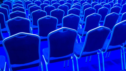 Obraz premium Rows of blue chairs. The chairs are blue. Many chairs.