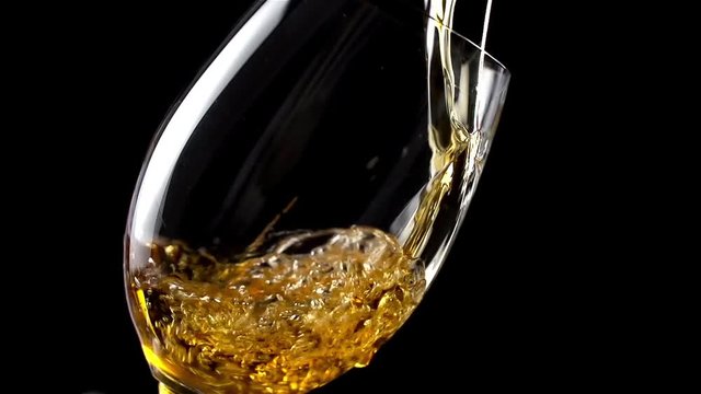 White wine  pouring into glass in slow motion 200 fps