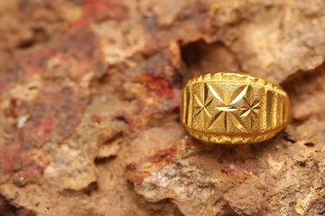 Old golden ring on stone texture