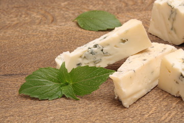 Cheese with a mold on a wooden background