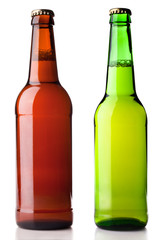 Twp different bottles of beer (green and brown) isolated on white background