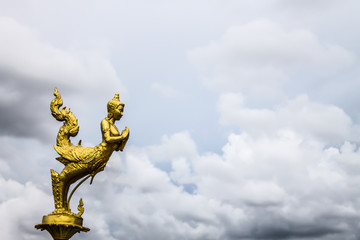 Thai statue kinnaree gold sky