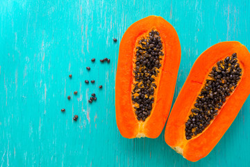 Papaya fruit on wooden background.Slices of sweet papaya on wooden background,Halved papayas with...