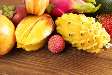 Tasty exotic fruits on wooden background