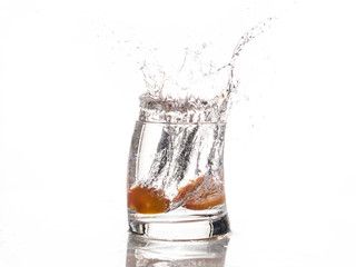Tomato falls in a glass of water - Splash