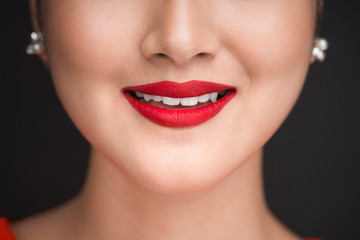 Fototapeta premium Beauty. Close up view of beautiful woman lips with red matt lipstick
