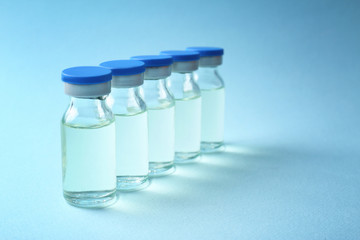 Medical ampules on colour background. Vaccination concept