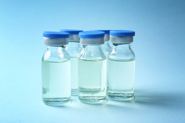 Medical ampules on colour background. Vaccination concept