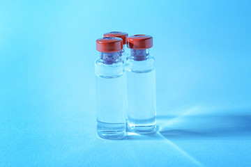 Medical ampules on colour background. Vaccination concept