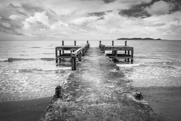 Black and white image of the old jetty, in a scary atmosphere.