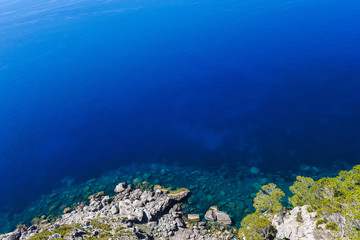 Naklejka na ściany i meble Beautiful travel landscape of Mallorca island of Spain on a sunny day a blue sky and azure sea near stony rocks