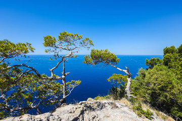 Fototapeta na wymiar Beautiful travel landscape of Mallorca island of Spain on a sunny day a blue sky and azure sea near stony rocks