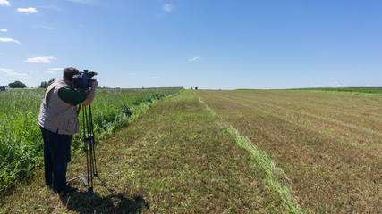 The cameraman shoots the forage preparation process on the camera. Agriculture.