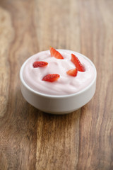 organic strawberry yogurt on wooden table