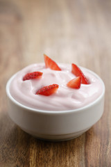 organic strawberry yogurt on wooden table